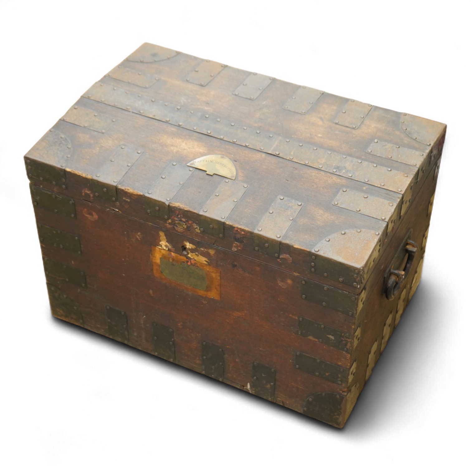 A iron bound oak chest with a fitted interior and removable trays to house an extensive dining set, owned by Captain Norman Bedingfield R.N., with an applied brass plaque to the lid engraved ‘Captain Bedingfield’, togeth